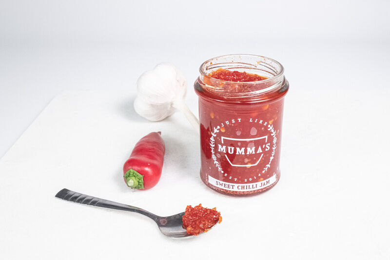 Example of product photography showing jam, spoon, chilli and garlic.